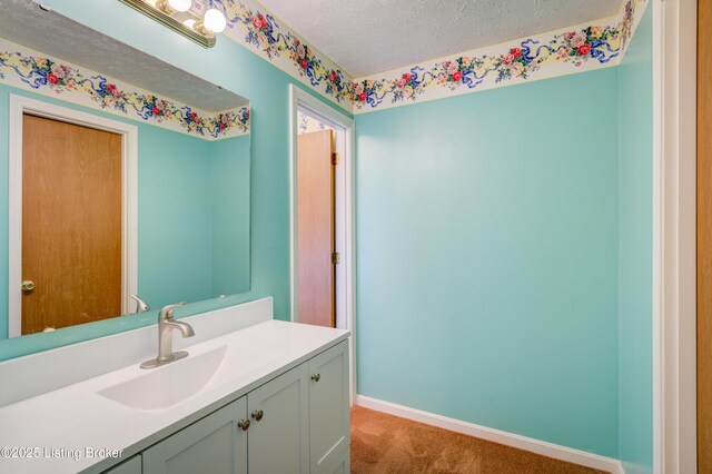 7003 Red Plum Ter, Pewee Valley, KY 40056 - bathroom with vanity, a textured ceiling, and baseboards