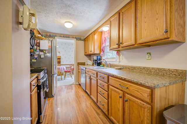 7003 Red Plum Ter, Pewee Valley, KY 40056 - kitchen with appliances with stainless steel finishes, a sink, light wood-style flooring, light countertops, and brown cabinetry