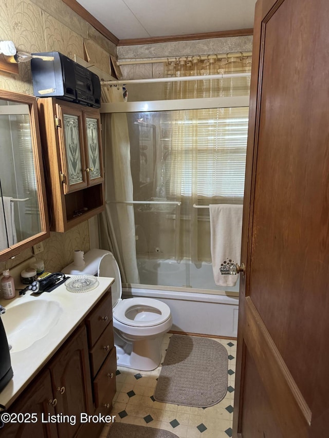 216 Bonnie Ln, Louisville, KY 40218 - bathroom featuring vanity, toilet, wallpapered walls, bath / shower combo with glass door, and tile patterned floors