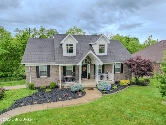 116 N Howard St, Bardstown, KY 40004 - new england style home with brick siding, a porch, and a shingled roof