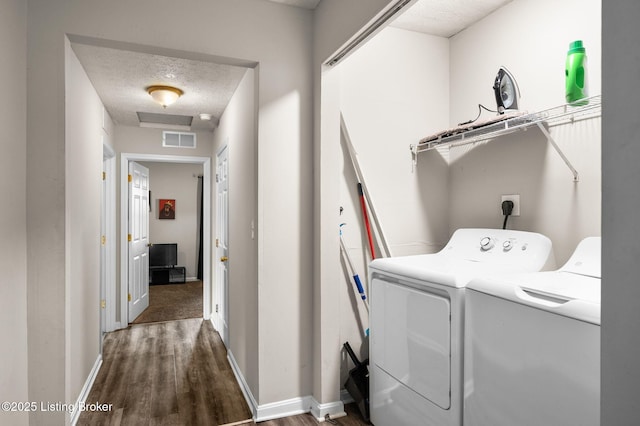 1136 Euclid Ave, Louisville, KY 40208 - laundry room featuring washing machine and dryer, wood finished floors, baseboards, and a textured ceiling