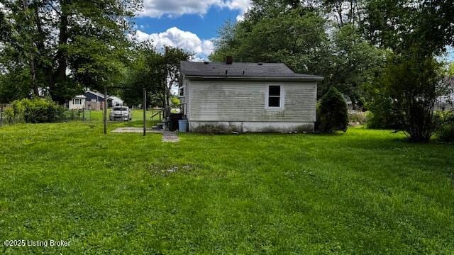 view of side of property with a lawn