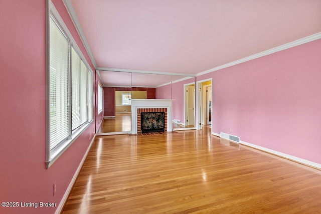 3531 Graham Rd, Louisville, KY 40207 - unfurnished living room with ornamental molding, a brick fireplace, and light wood finished floors