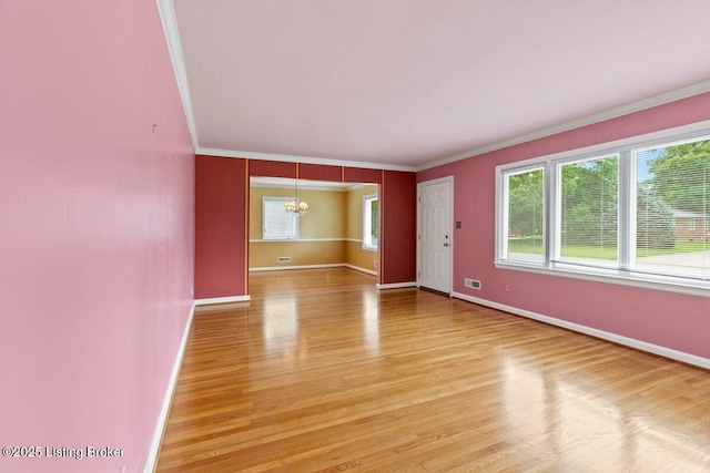 3531 Graham Rd, Louisville, KY 40207 - unfurnished room with a chandelier, healthy amount of natural light, ornamental molding, and light wood-style flooring