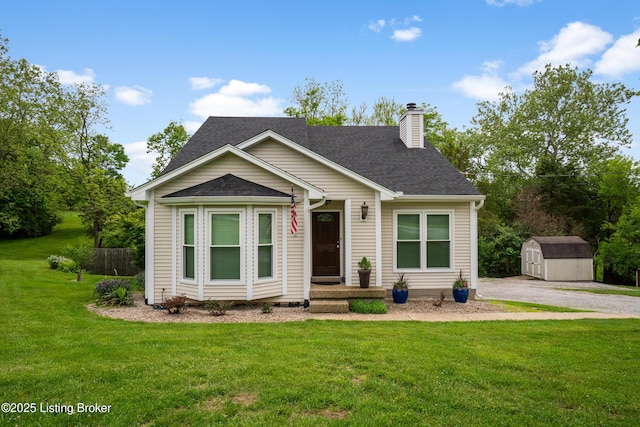 1900 Wolf Dr, La Grange, KY 40031 - view of front of home featuring a shed, a chimney, an outdoor structure, a front lawn, and a shingled roof