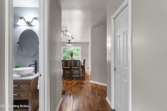 1900 Wolf Dr, La Grange, KY 40031 - corridor featuring dark wood-style floors, a sink, baseboards, and track lighting