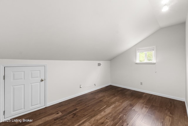 1900 Wolf Dr, La Grange, KY 40031 - additional living space with lofted ceiling, dark wood-style flooring, and baseboards
