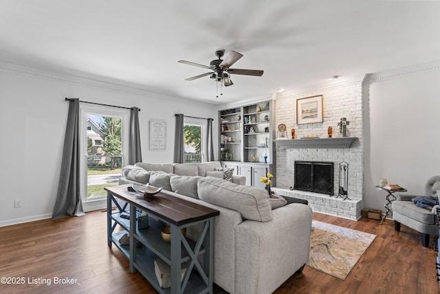 1609 Tall Oaks Dr, Jeffersonville, IN 47130 - living room with a ceiling fan, dark wood-type flooring, a brick fireplace, built in shelves, and ornamental molding