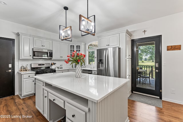 1609 Tall Oaks Dr, Jeffersonville, IN 47130 - kitchen featuring appliances with stainless steel finishes, dark wood finished floors, light countertops, and healthy amount of natural light