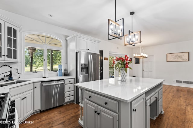 1609 Tall Oaks Dr, Jeffersonville, IN 47130 - kitchen with stainless steel appliances, a chandelier, a sink, gray cabinetry, and a center island