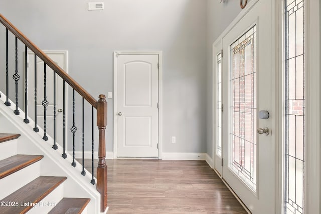 566 Wooded Falls Rd, Louisville, KY 40243 - foyer entrance with wood finished floors, a high ceiling, stairs, and baseboards