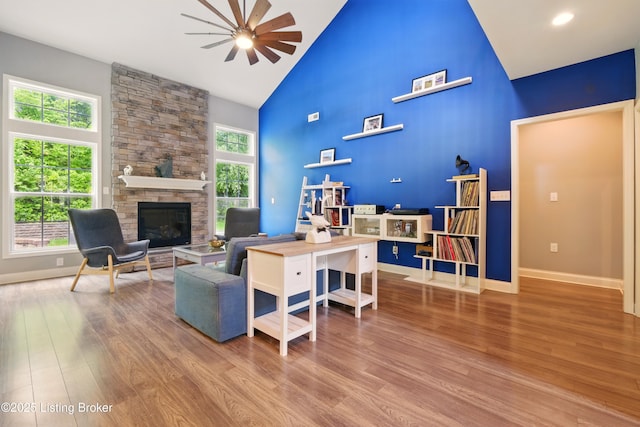 566 Wooded Falls Rd, Louisville, KY 40243 - living area with high vaulted ceiling, ceiling fan, wood finished floors, a stone fireplace, and baseboards