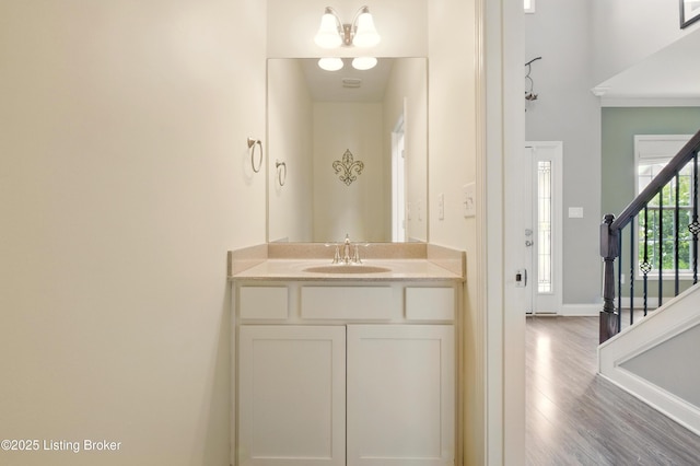 566 Wooded Falls Rd, Louisville, KY 40243 - bathroom with wood finished floors, baseboards, vanity, and ornamental molding