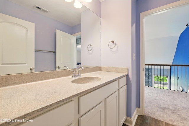 566 Wooded Falls Rd, Louisville, KY 40243 - bathroom with wood finished floors, vanity, and baseboards