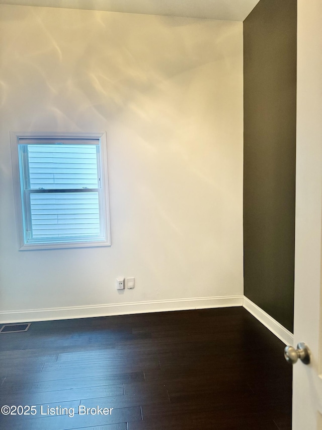 941 E Oak St, Louisville, KY 40204 - empty room with baseboards and dark wood-type flooring