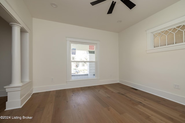 426 E Oak St, Louisville, KY 40203 - spare room with ornate columns, a ceiling fan, wood finished floors, and baseboards