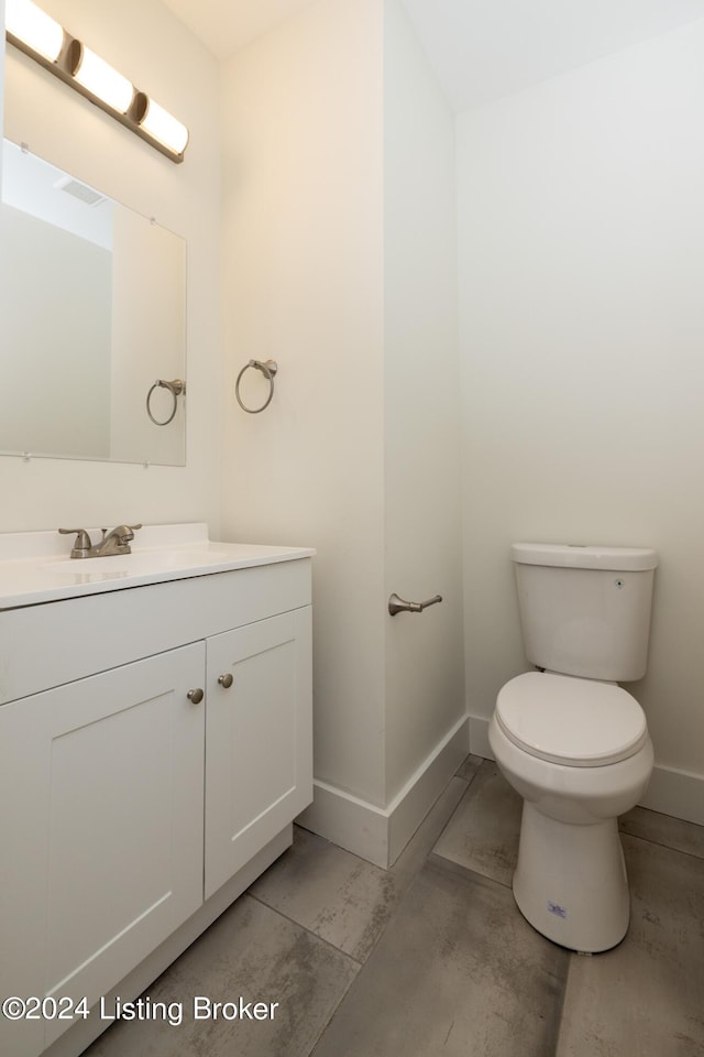426 E Oak St, Louisville, KY 40203 - bathroom featuring baseboards, toilet, and vanity
