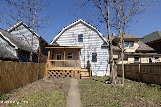 426 E Oak St, Louisville, KY 40203 - view of front of house with covered porch, a gambrel roof, and fence