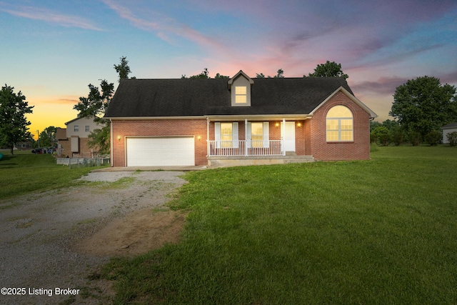228 Schlaefer Way, Rineyville, KY 40162 - cape cod house featuring driveway, brick siding, a porch, and a yard