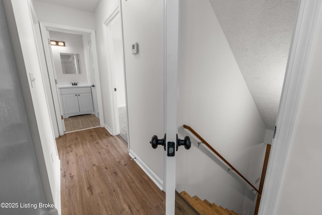 228 Schlaefer Way, Rineyville, KY 40162 - corridor featuring an upstairs landing, light wood finished floors, a sink, and baseboards