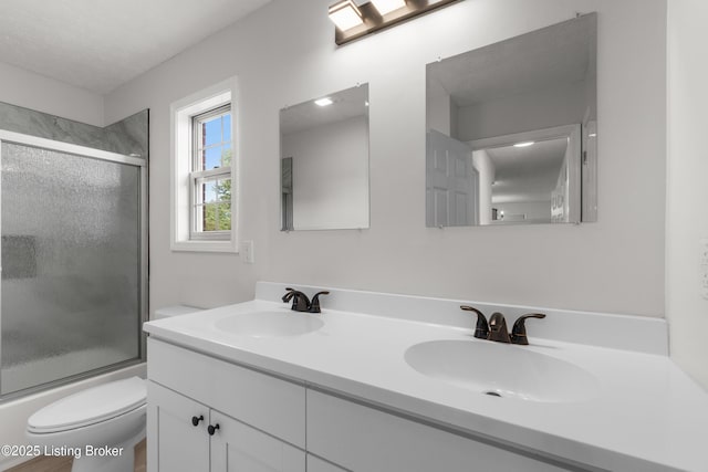 228 Schlaefer Way, Rineyville, KY 40162 - bathroom featuring toilet, double vanity, and bath / shower combo with glass door