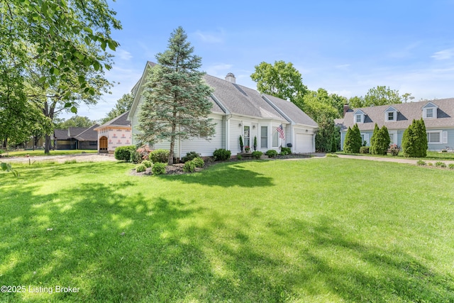 view of front of home with a garage, a front lawn, and asphalt driveway