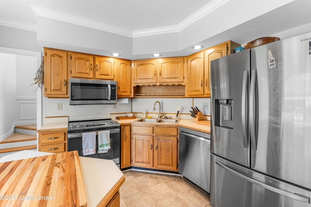 kitchen with stainless steel appliances, a sink, light countertops, crown molding, and light tile patterned floors
