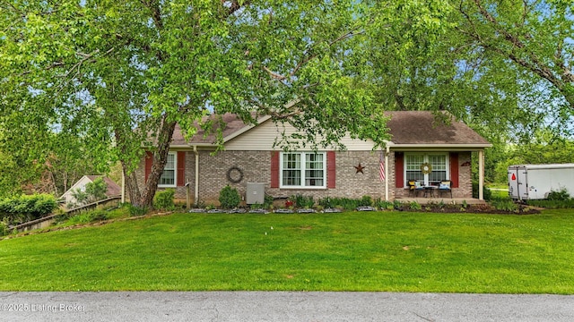 view of front facade featuring a front lawn, brick siding, and a porch