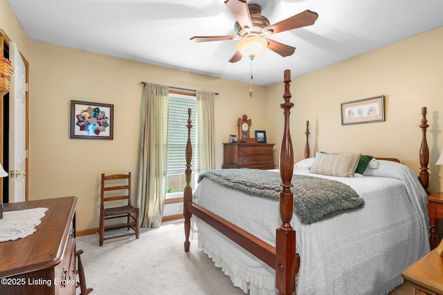 bedroom featuring light colored carpet, baseboards, and ceiling fan