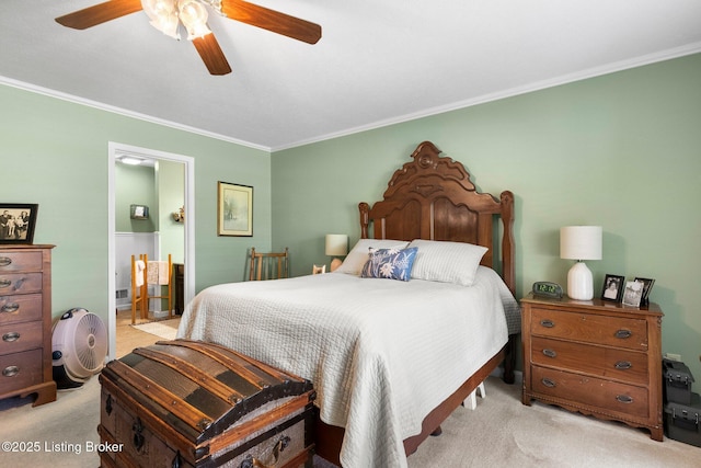 bedroom featuring light carpet, ornamental molding, ensuite bathroom, and a ceiling fan