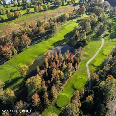 view of property location featuring a golf course and a large body of water