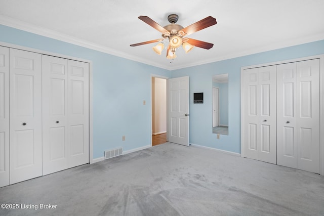 1160 Buck Knobs Rd, Ekron, KY 40117 - unfurnished bedroom with carpet flooring, baseboards, ornamental molding, a ceiling fan, and two closets