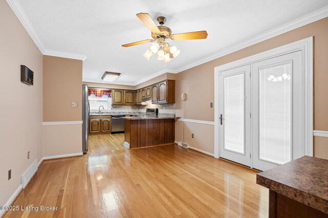 1160 Buck Knobs Rd, Ekron, KY 40117 - kitchen with stainless steel appliances, a peninsula, light wood-style flooring, a ceiling fan, and ornamental molding