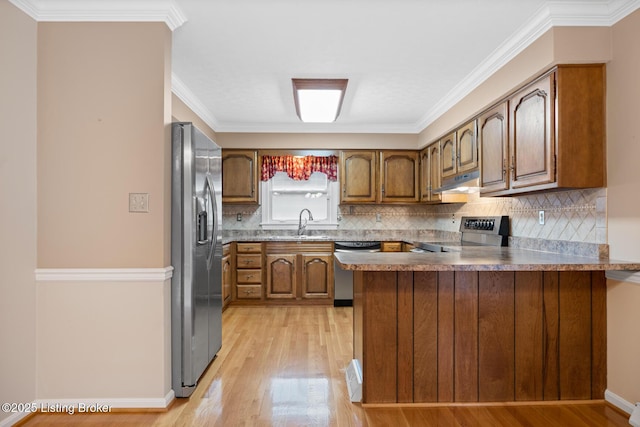 1160 Buck Knobs Rd, Ekron, KY 40117 - kitchen with appliances with stainless steel finishes, a peninsula, brown cabinets, light wood-style floors, and tasteful backsplash