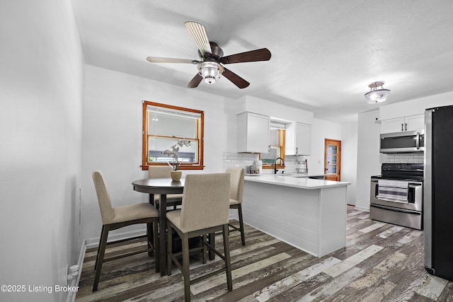 2700 Bagby Way, Louisville, KY 40216 - dining area with wood finished floors, a ceiling fan, and baseboards
