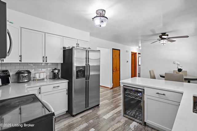 2700 Bagby Way, Louisville, KY 40216 - kitchen featuring stainless steel refrigerator with ice dispenser, beverage cooler, black / electric stove, light countertops, and white cabinets