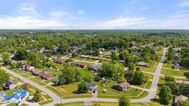 aerial perspective of suburban area featuring a heavily wooded area