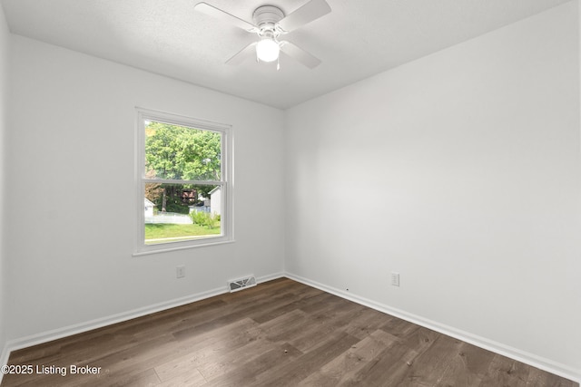 unfurnished room with dark wood-style floors, baseboards, and ceiling fan