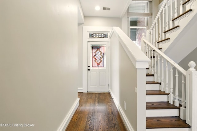 staircase with wood finished floors and baseboards