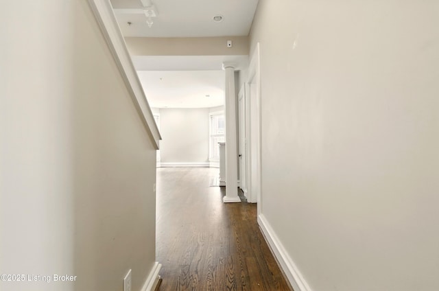 hall featuring dark wood-style floors and baseboards