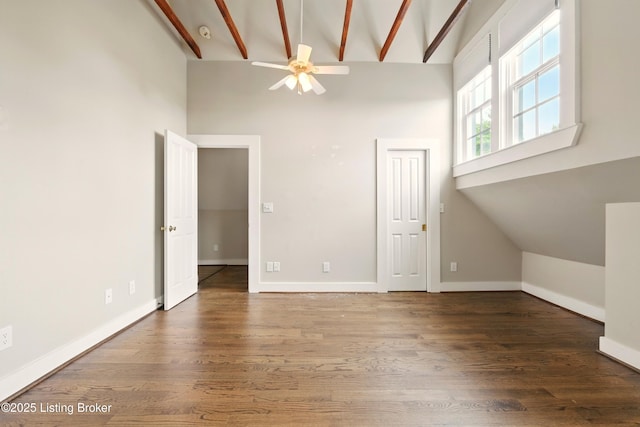 unfurnished living room featuring high vaulted ceiling, ceiling fan, wood finished floors, baseboards, and beam ceiling