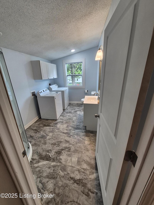 119 Melton Ave, Elizabethtown, KY 42701 - clothes washing area featuring washer and dryer, baseboards, a textured ceiling, and cabinet space