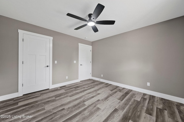 314 Nolin Estates Rd, Clarkson, KY 42726 - unfurnished bedroom featuring wood finished floors, baseboards, and ceiling fan