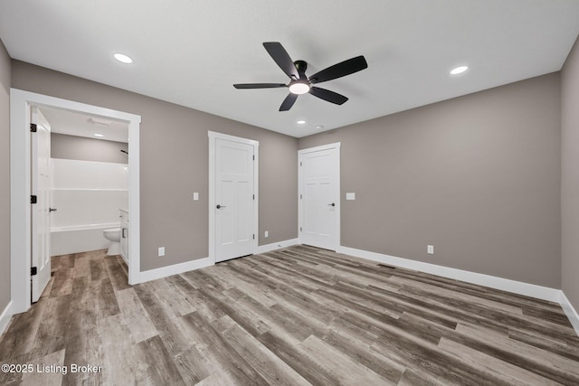 314 Nolin Estates Rd, Clarkson, KY 42726 - unfurnished bedroom with wood finished floors, baseboards, ensuite bathroom, recessed lighting, and ceiling fan