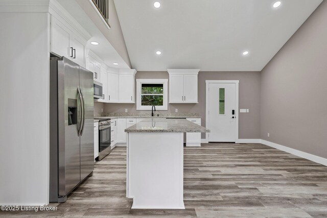 314 Nolin Estates Rd, Clarkson, KY 42726 - kitchen featuring appliances with stainless steel finishes, a sink, white cabinets, a center island, and baseboards