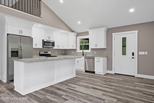 314 Nolin Estates Rd, Clarkson, KY 42726 - kitchen with appliances with stainless steel finishes, light wood-type flooring, white cabinetry, baseboards, and a center island