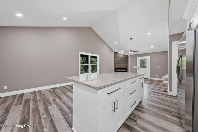 314 Nolin Estates Rd, Clarkson, KY 42726 - kitchen featuring freestanding refrigerator, ceiling fan, a fireplace, wood finished floors, and a kitchen island