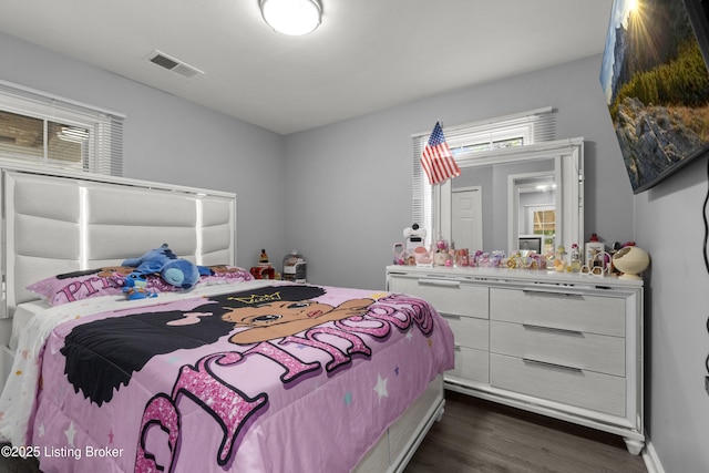 bedroom with dark wood-type flooring