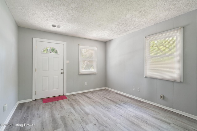 6614 Putman St, Louisville, KY 40216 - entryway featuring wood finished floors, a textured ceiling, and baseboards