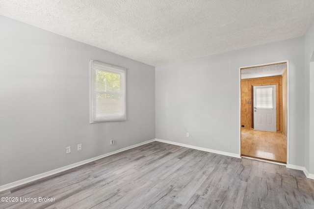 6614 Putman St, Louisville, KY 40216 - spare room featuring wood finished floors, a textured ceiling, and baseboards